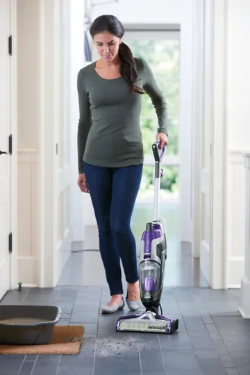 CrossWave Pet Pro Wet Dry Vac Vacuuming and Mopping kitty litter from hard flooring.