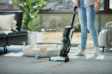 CrossWave Cordless Max Wet Dry Vac Vacuuming area rug.