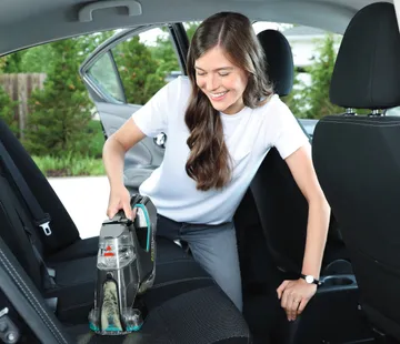 Pet Stain Eraser PowerBrush cleaning car upholstery.